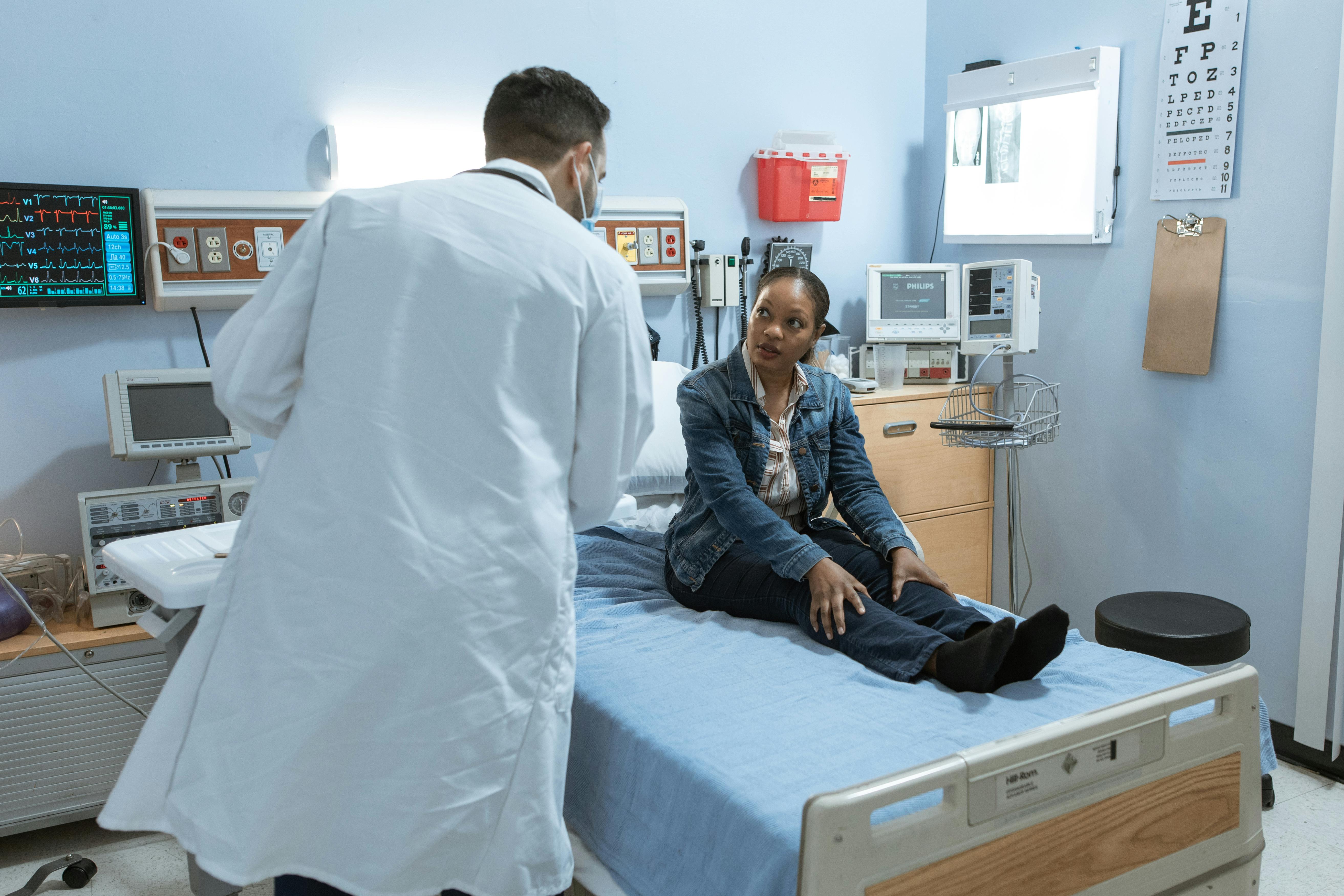 Doctor attending to patient in hospital room